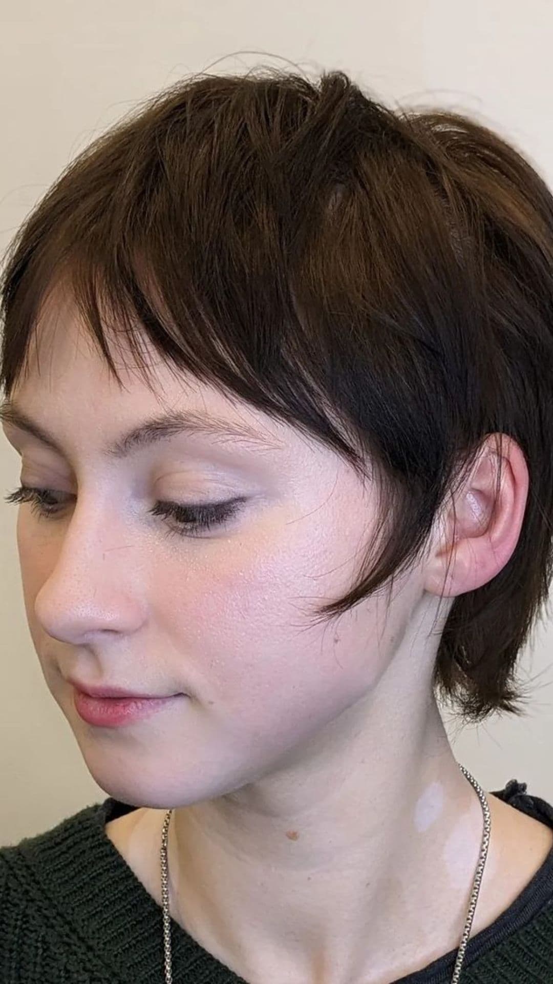 A woman modelling a Shaggy Pixie Mullet hairstyle.