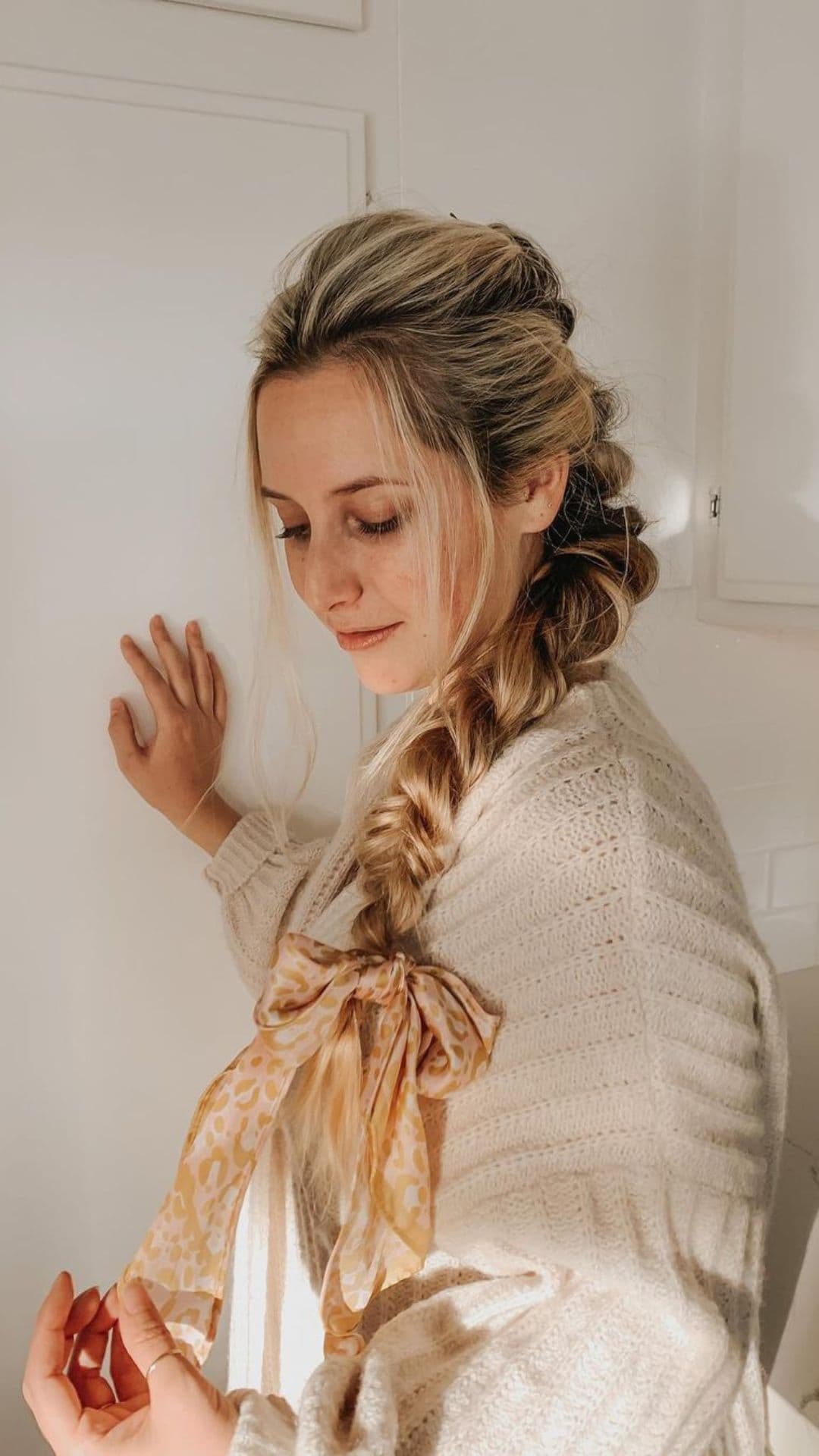 A woman modelling a Twisted Side Braid hairstyle.