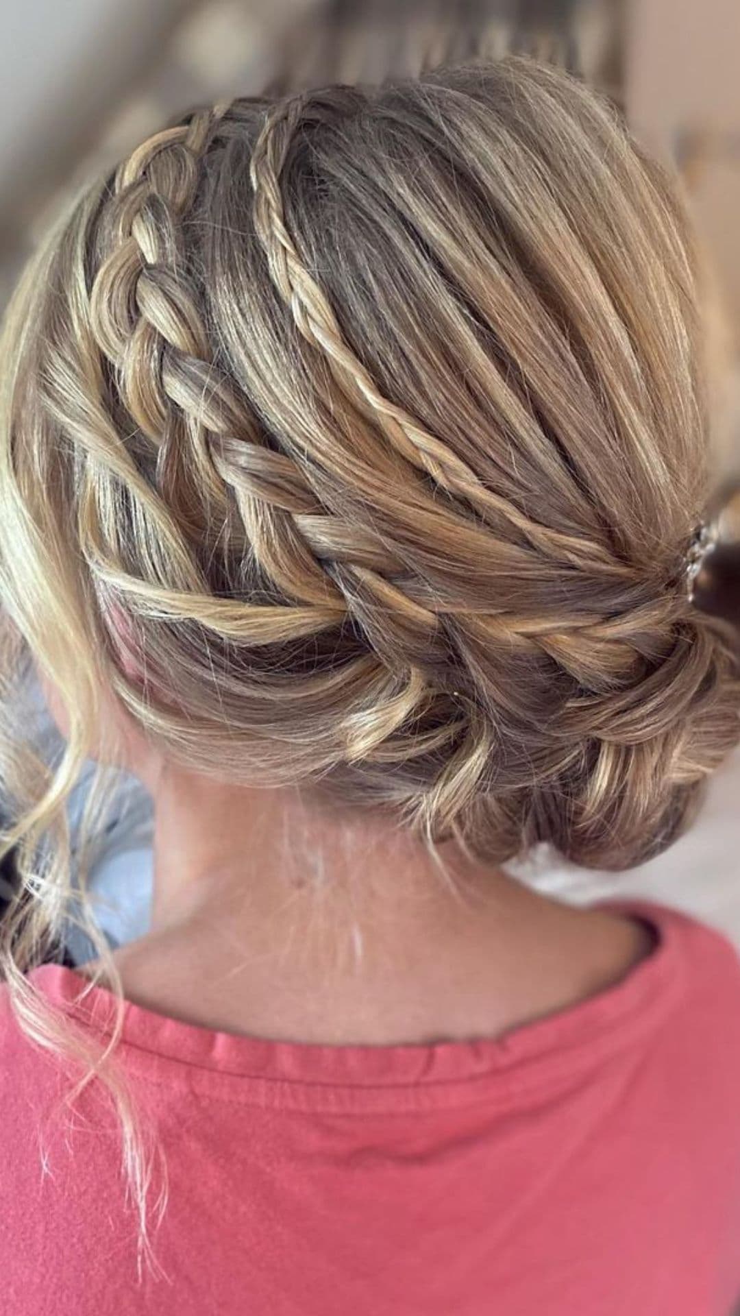 Woman with a neatly styled Double Braid hairstyle, showcasing intricate weaving, viewed from the back.