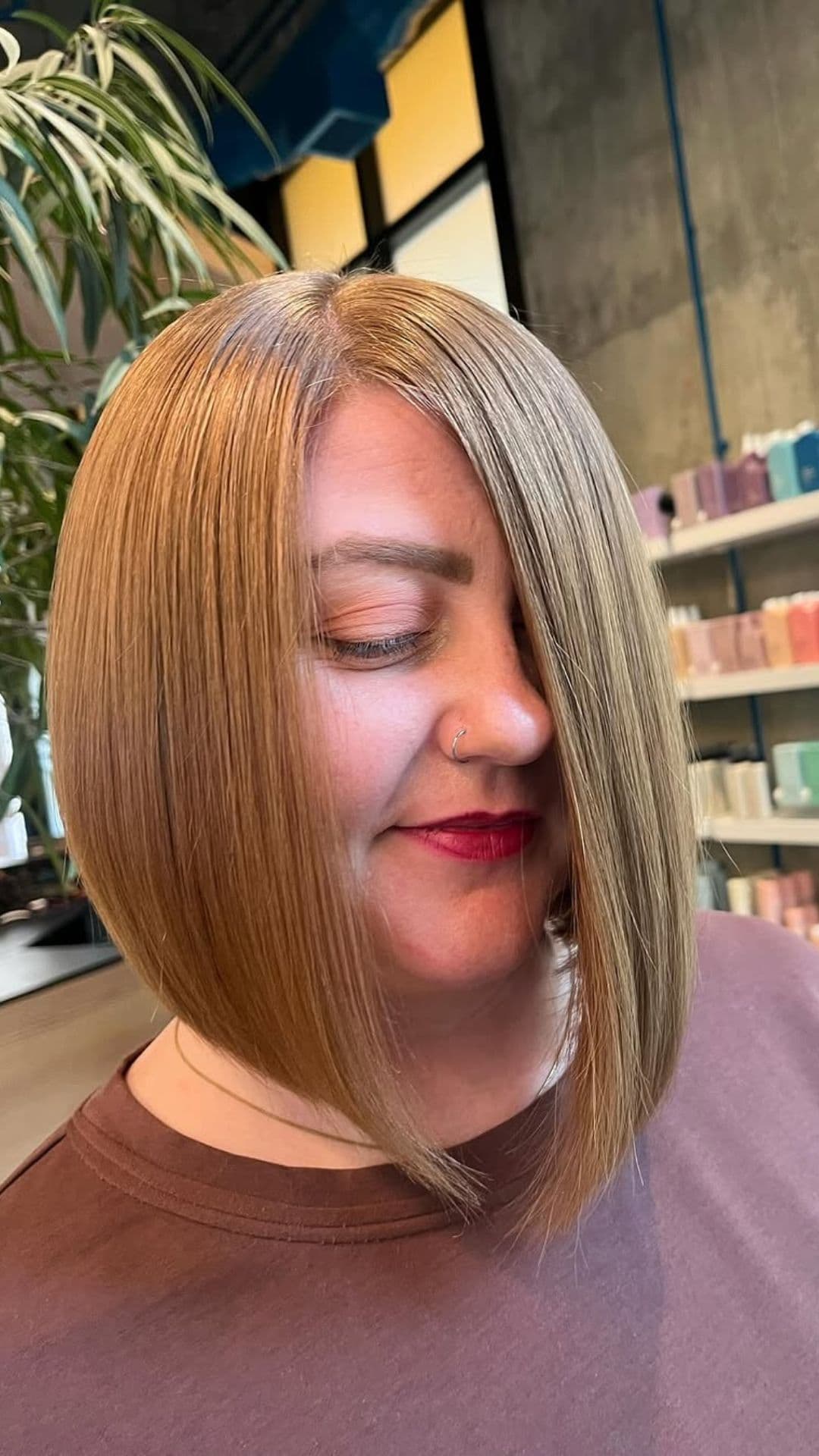 A woman with a round face modelling a A-Line Bob hairstyle.