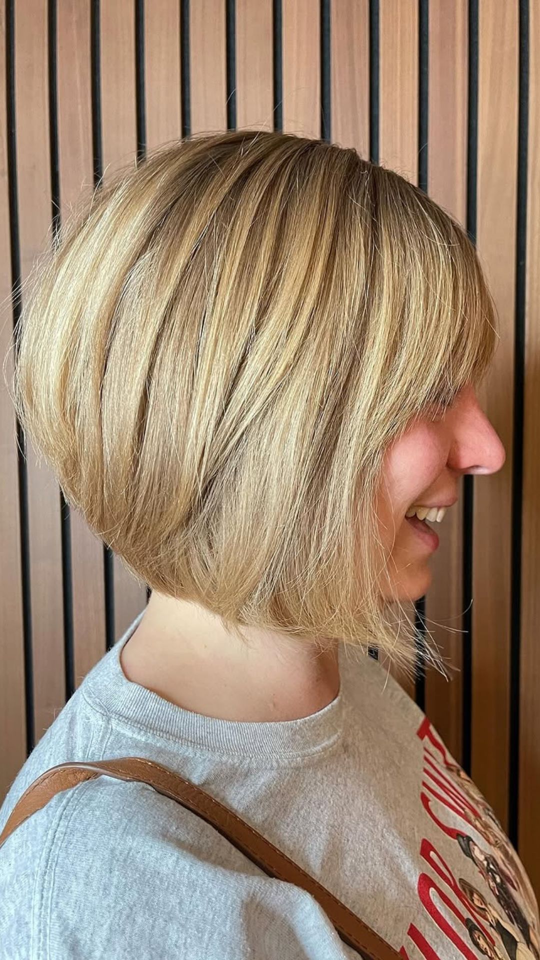 A round-faced woman with double chin modelling a Angled Bob hairstyle.