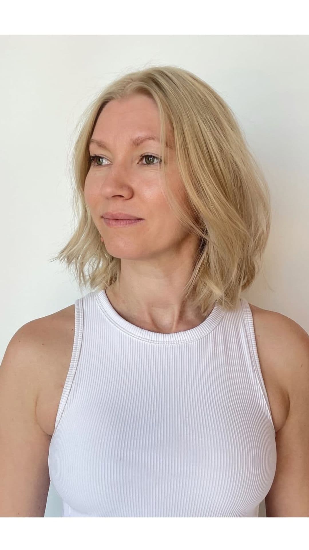 A woman with a round face modelling a Bob with Choppy Layers hairstyle.