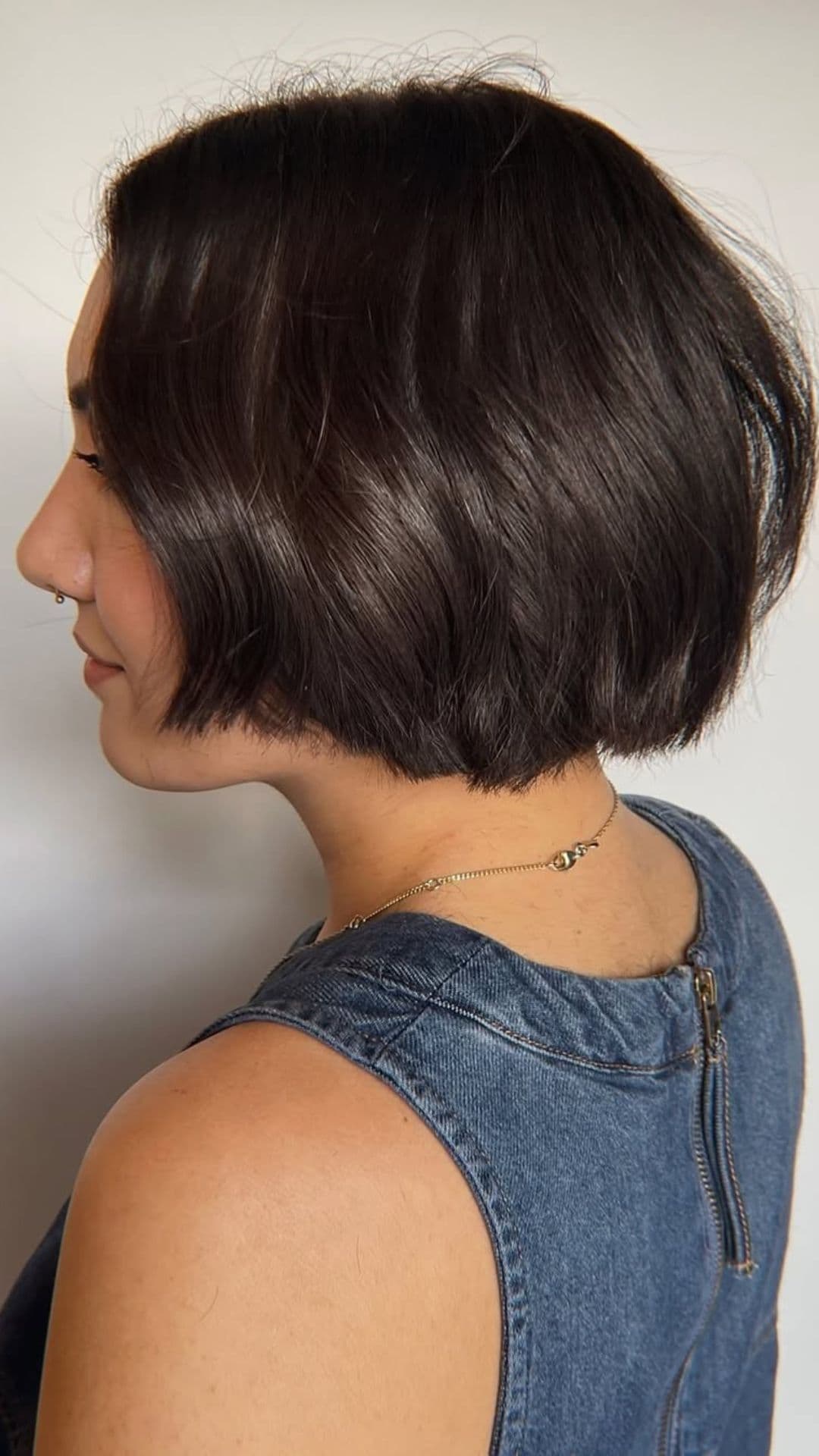 A woman with a round face modelling a Bob with Textured Ends hairstyle.