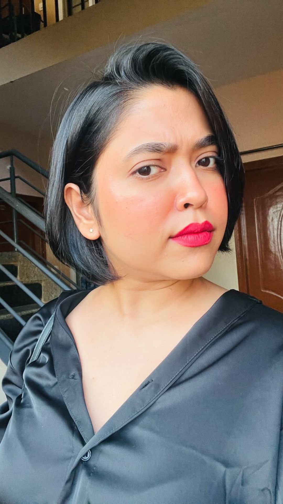 A round-faced woman with double chin modelling a Chin-Length Bob hairstyle.