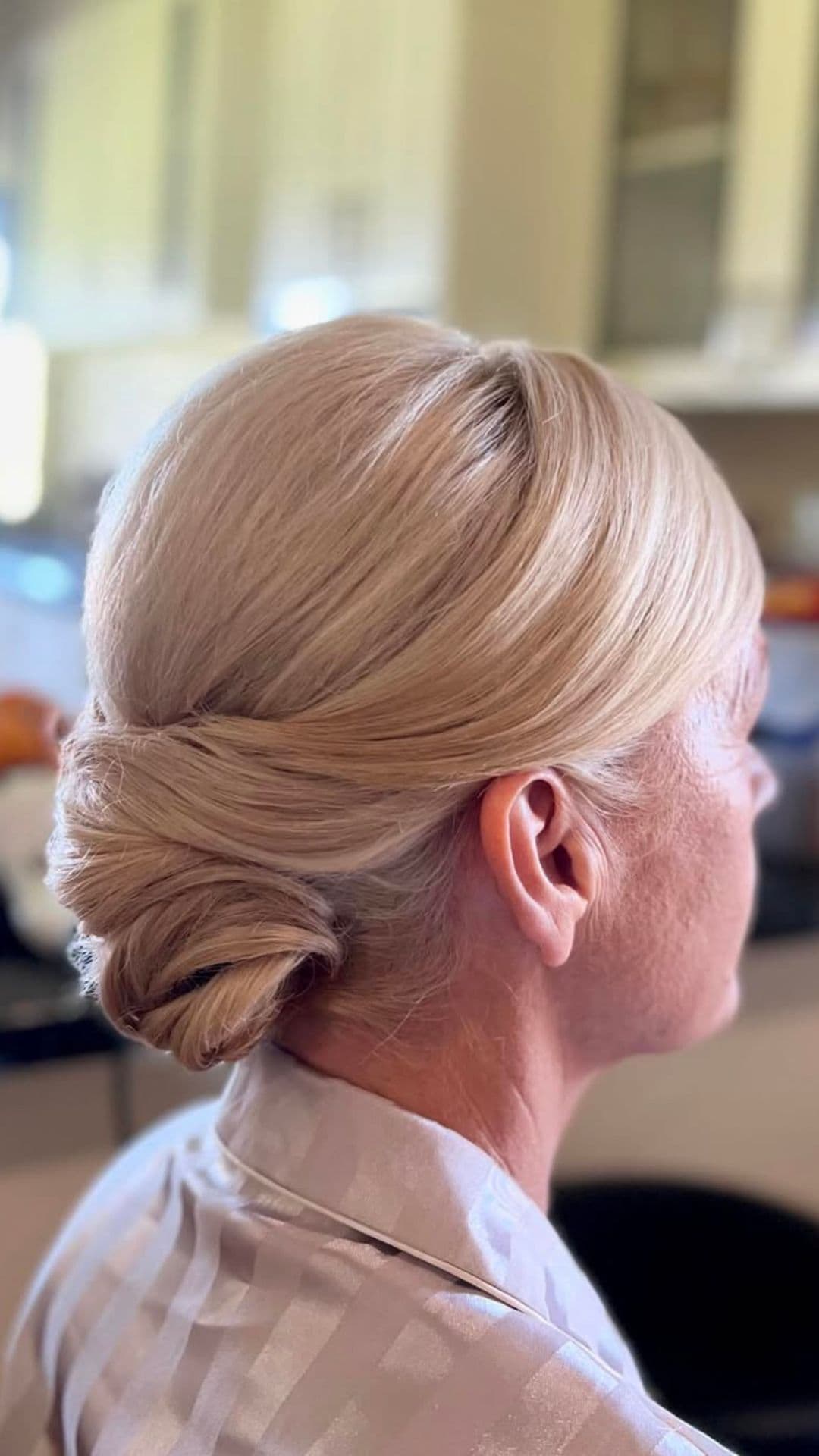 An old woman modelling a Classic Chignon hairstyle.
