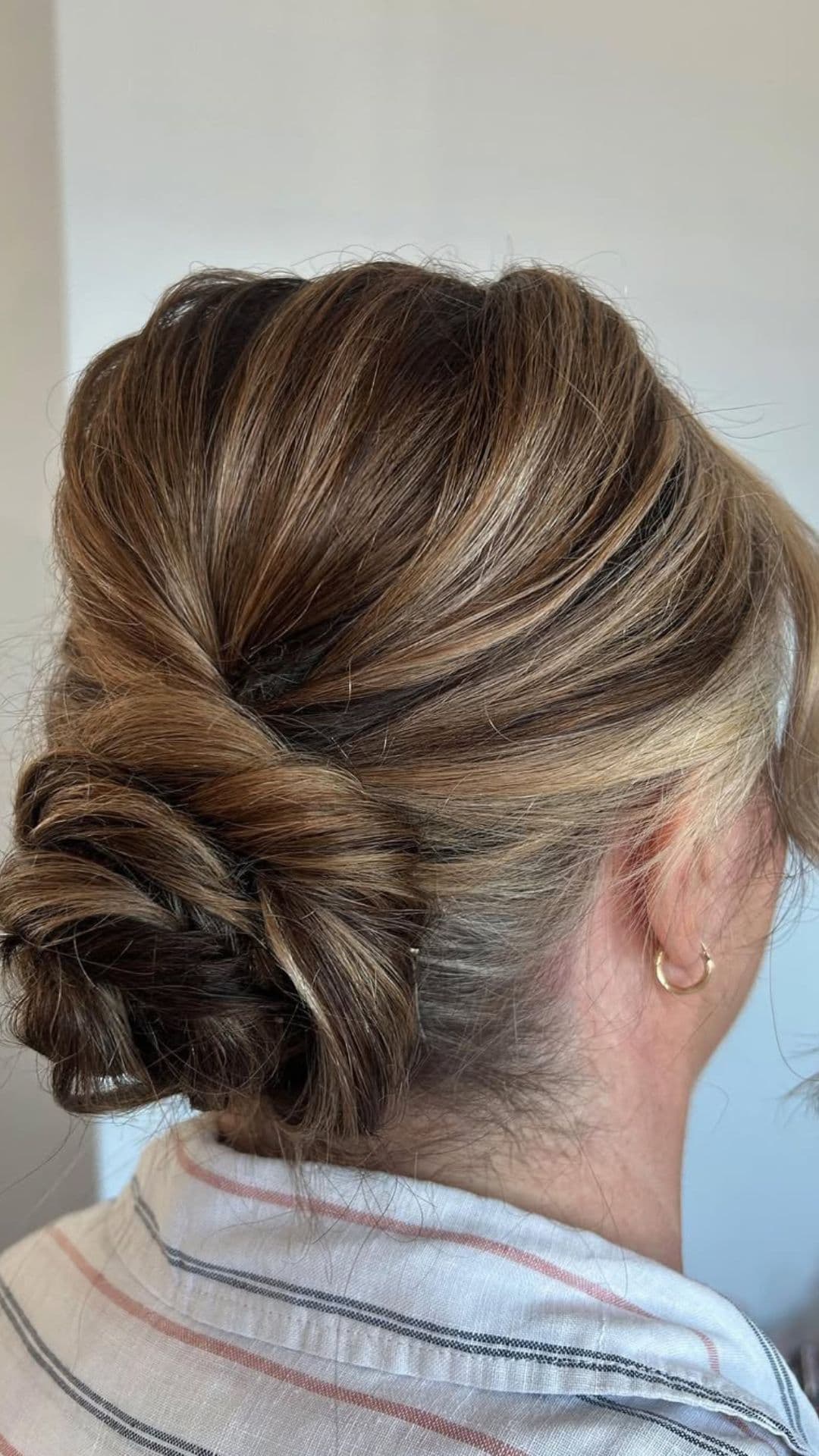 An old woman modelling a Classic Low Twist Bun hairstyle.