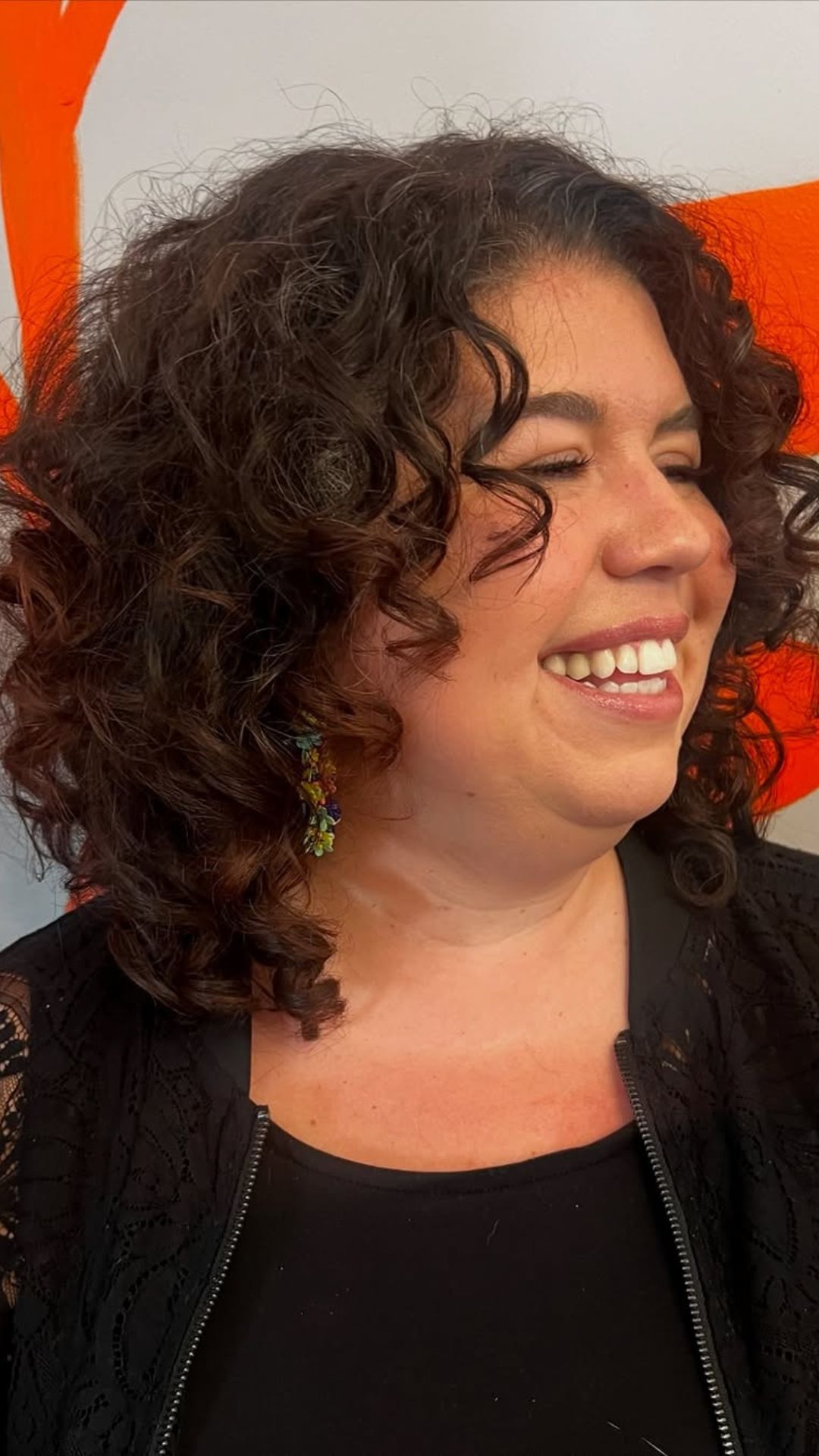 A round-faced woman with double chin modelling a Curly Bob hairstyle.