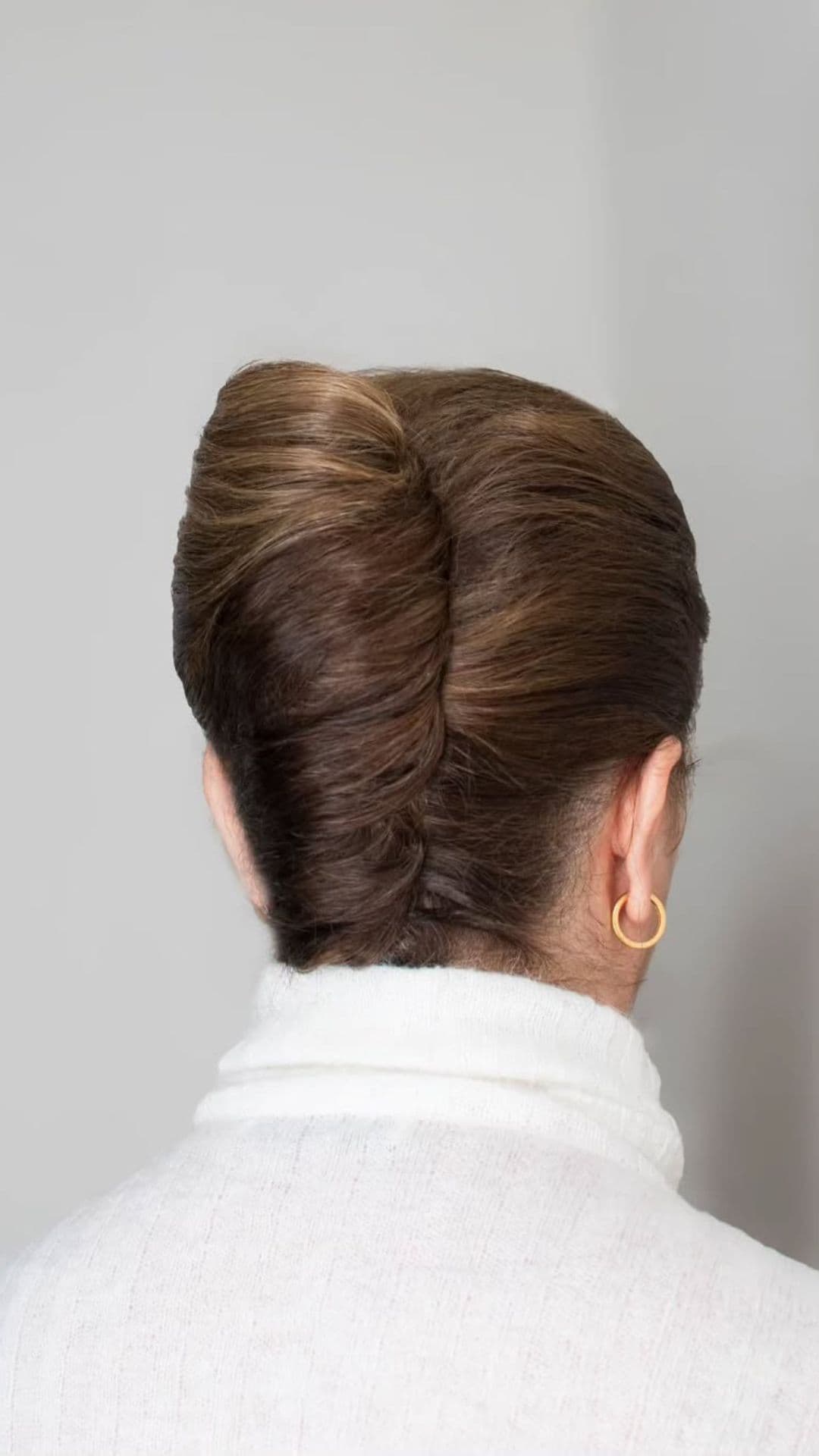 An old woman modelling a Elegant French Twist hairstyle.