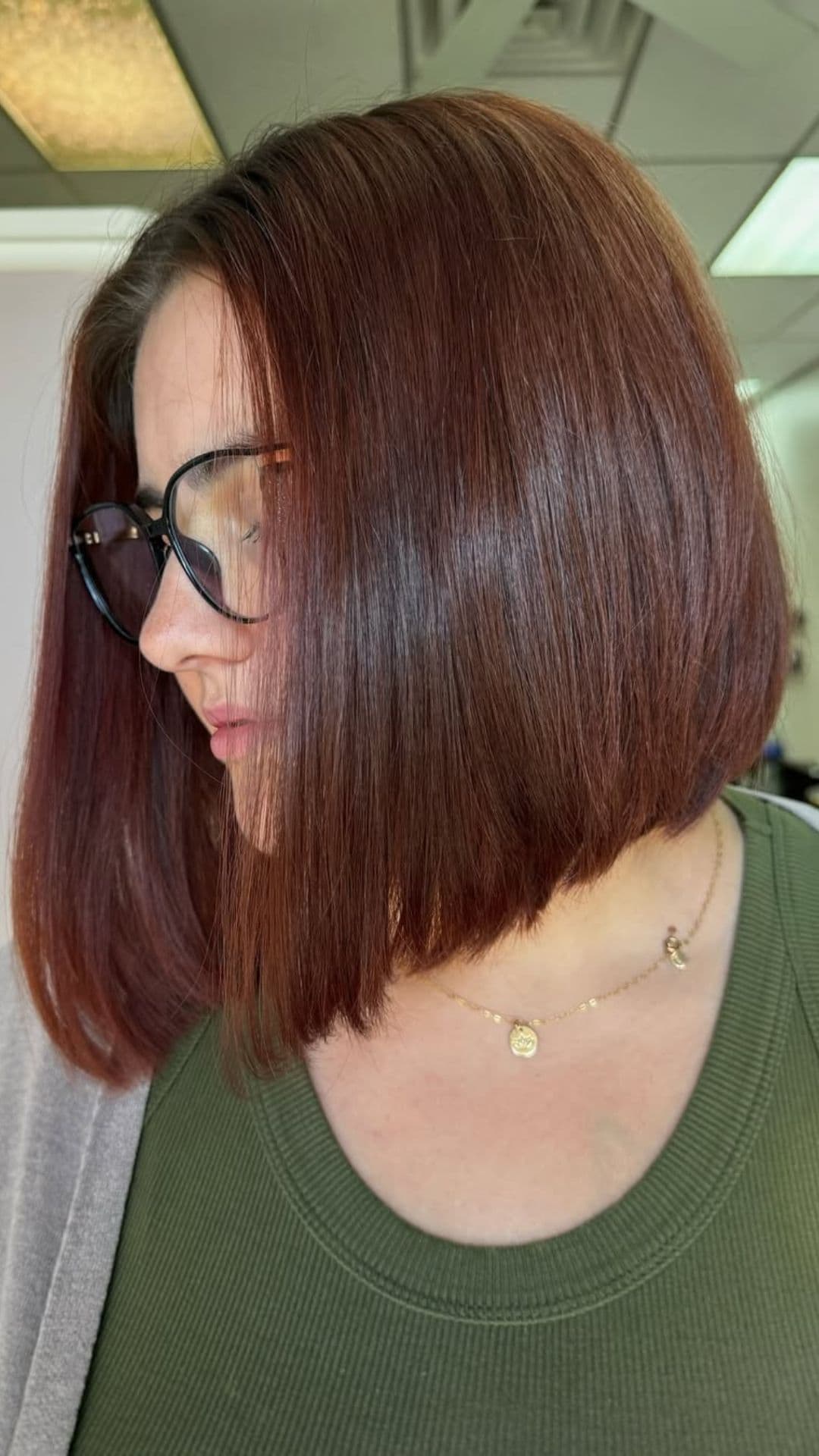 A woman with a round face modelling a Inverted Bob hairstyle.