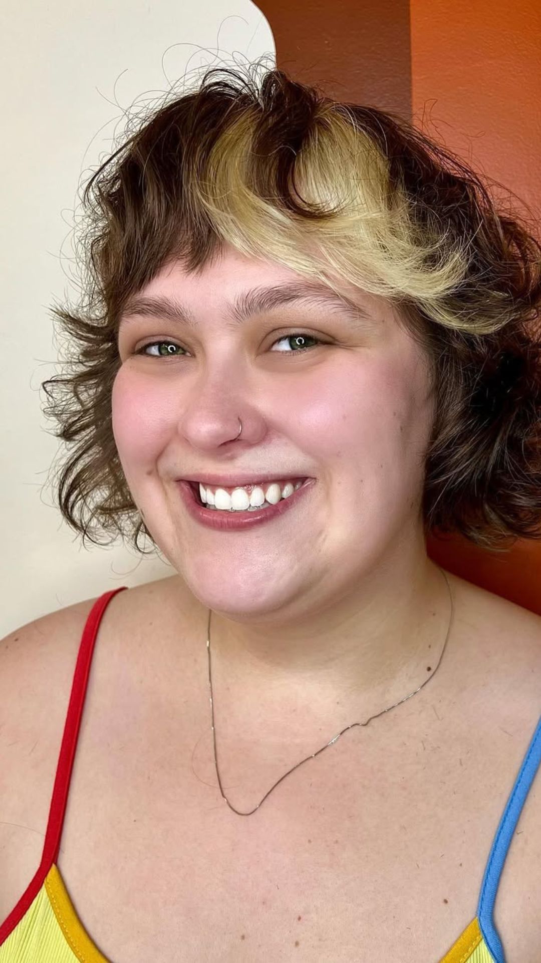 A round-faced woman with double chin modelling a Layered Bangs hairstyle.