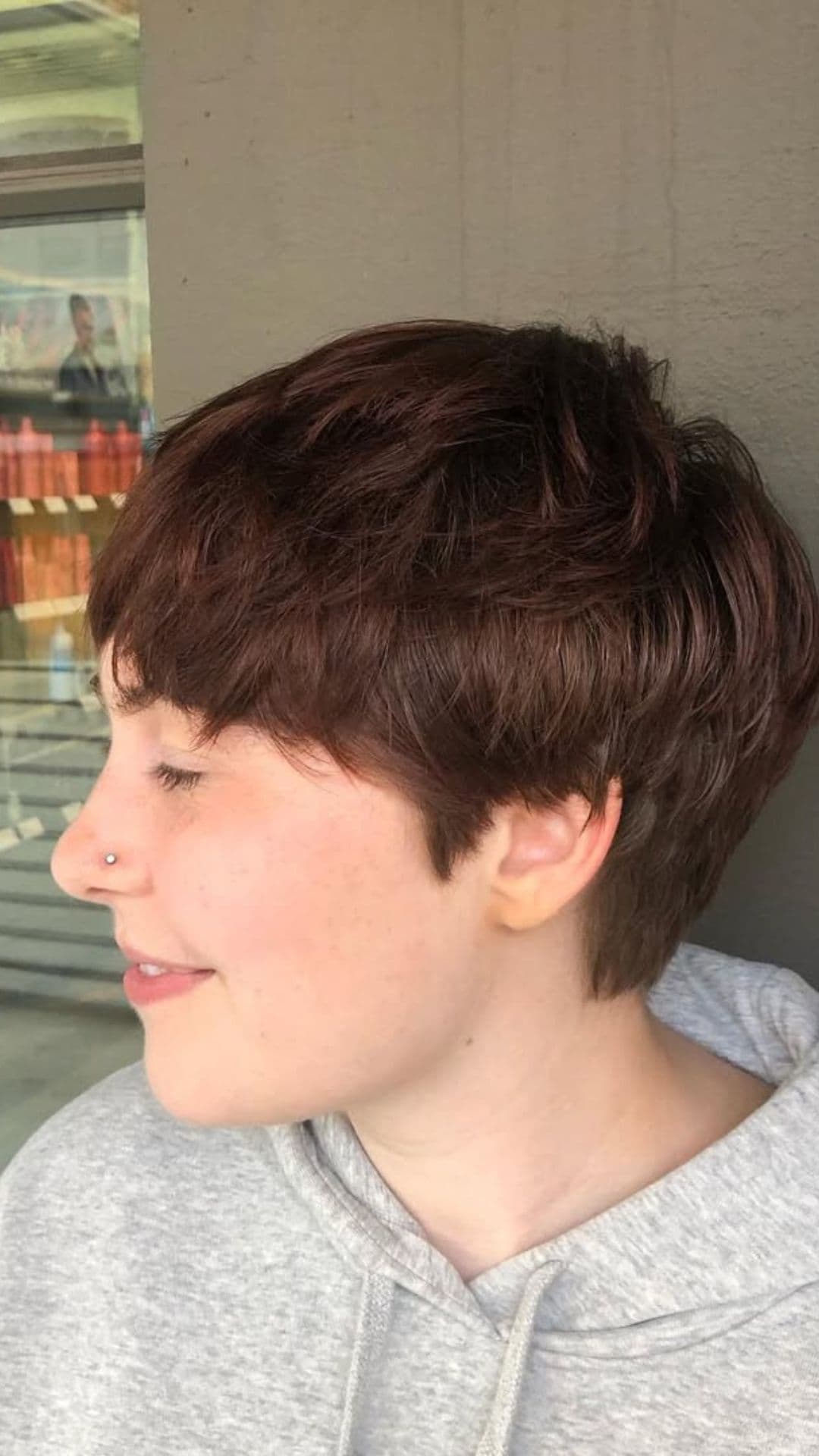 A round-faced woman with double chin modelling a Layered Pixie Cut hairstyle.