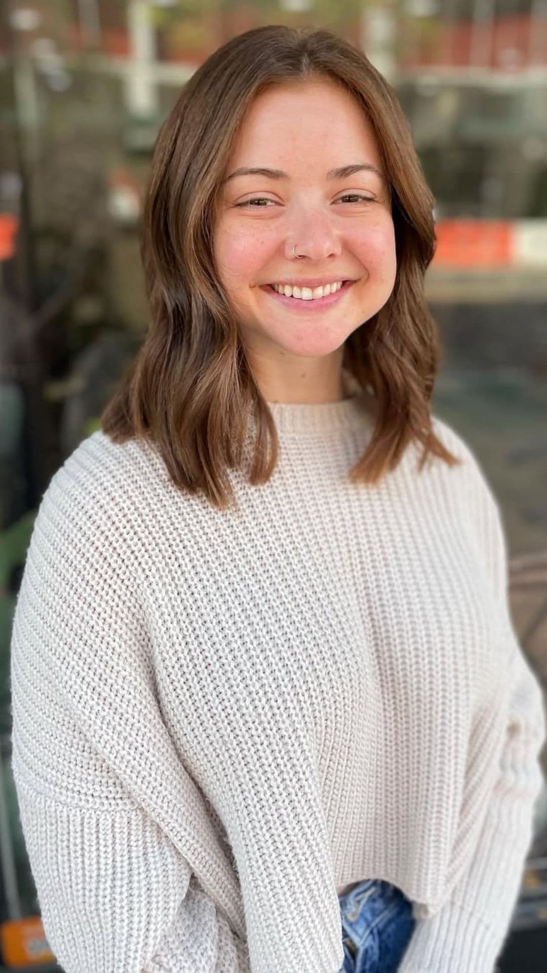 A woman with a round face modelling a Long Bob with Soft Waves hairstyle.