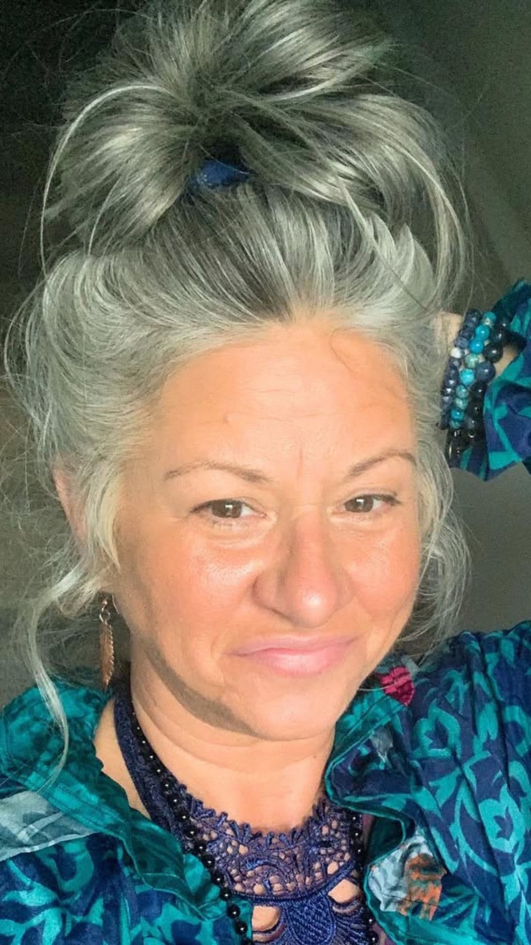 An old woman modelling a Messy Top Knot hairstyle.
