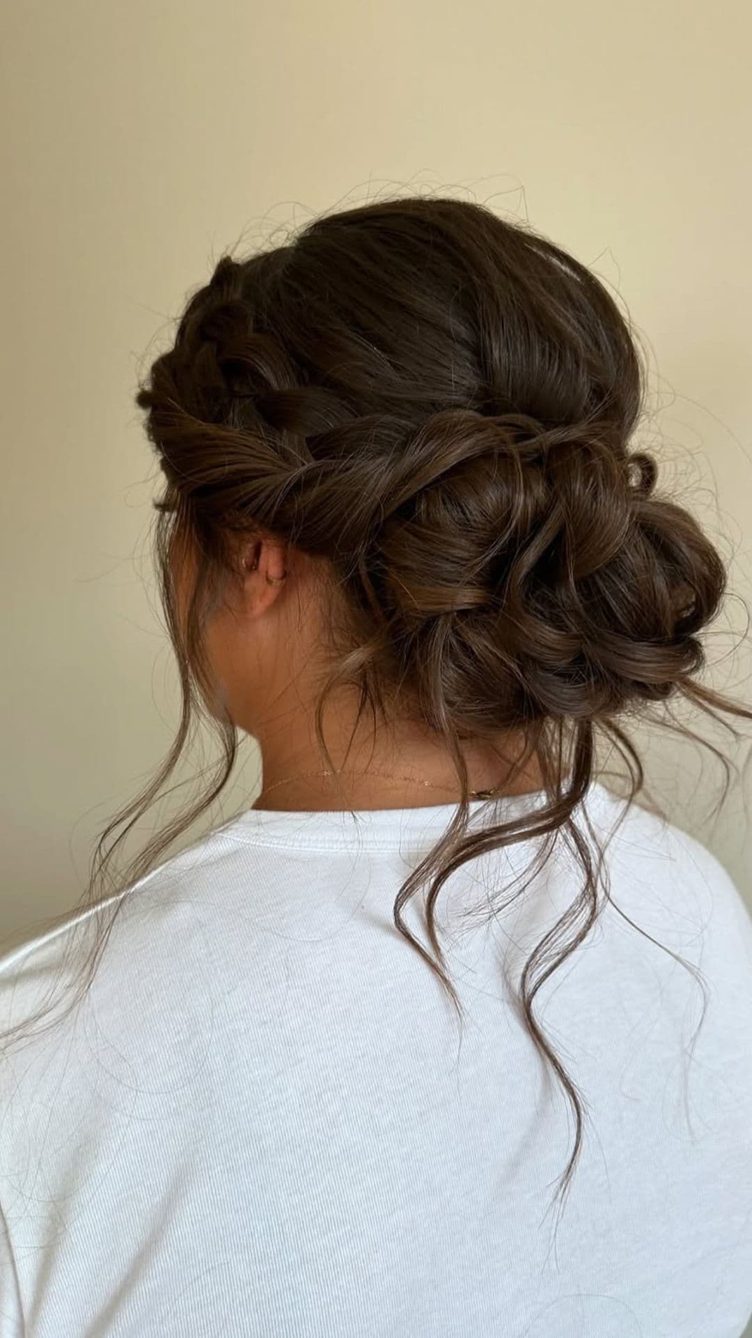 A round-faced woman with double chin modelling a Messy Updo hairstyle.