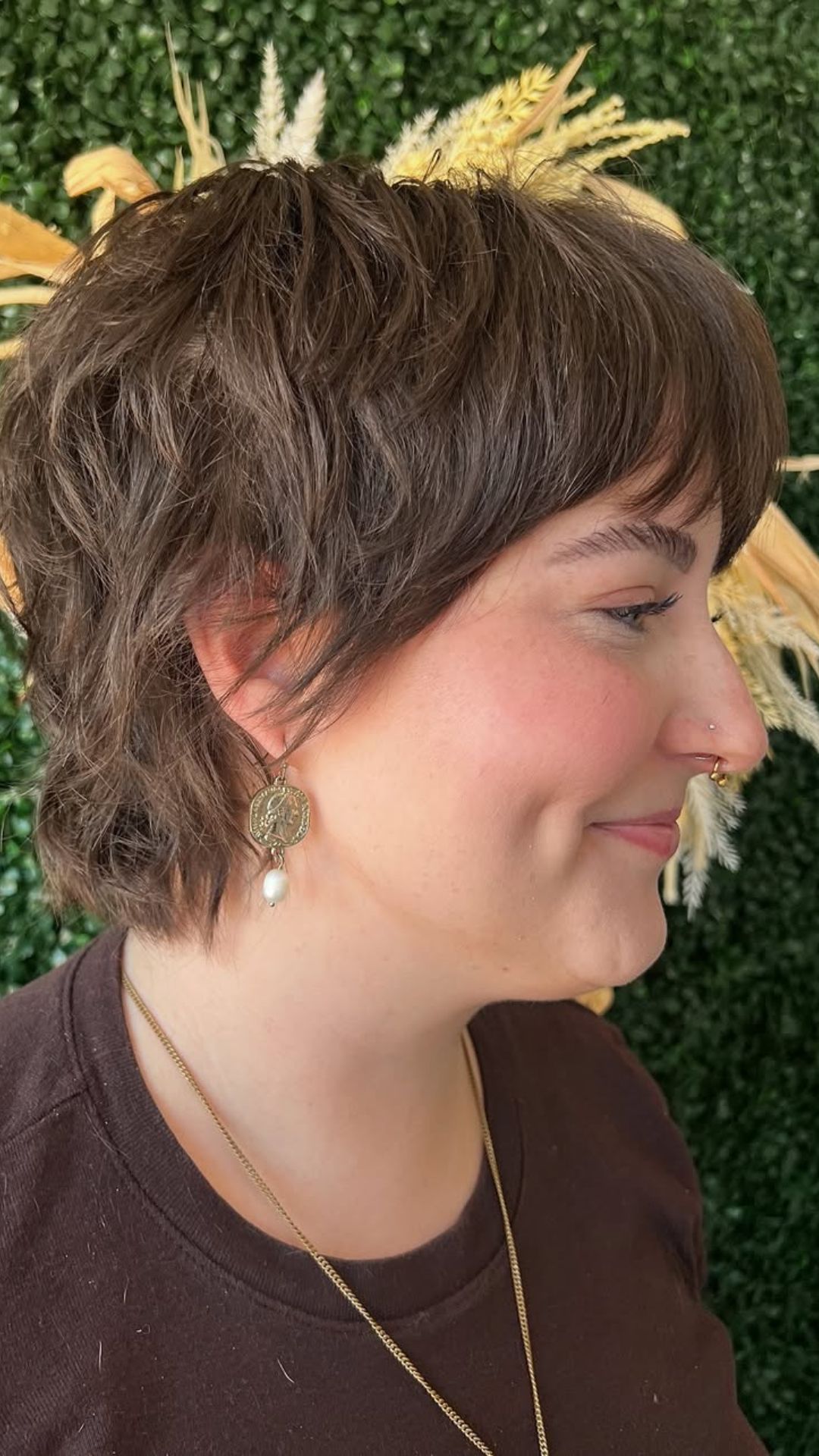 A round-faced woman with double chin modelling a Pixie with Bangs hairstyle.