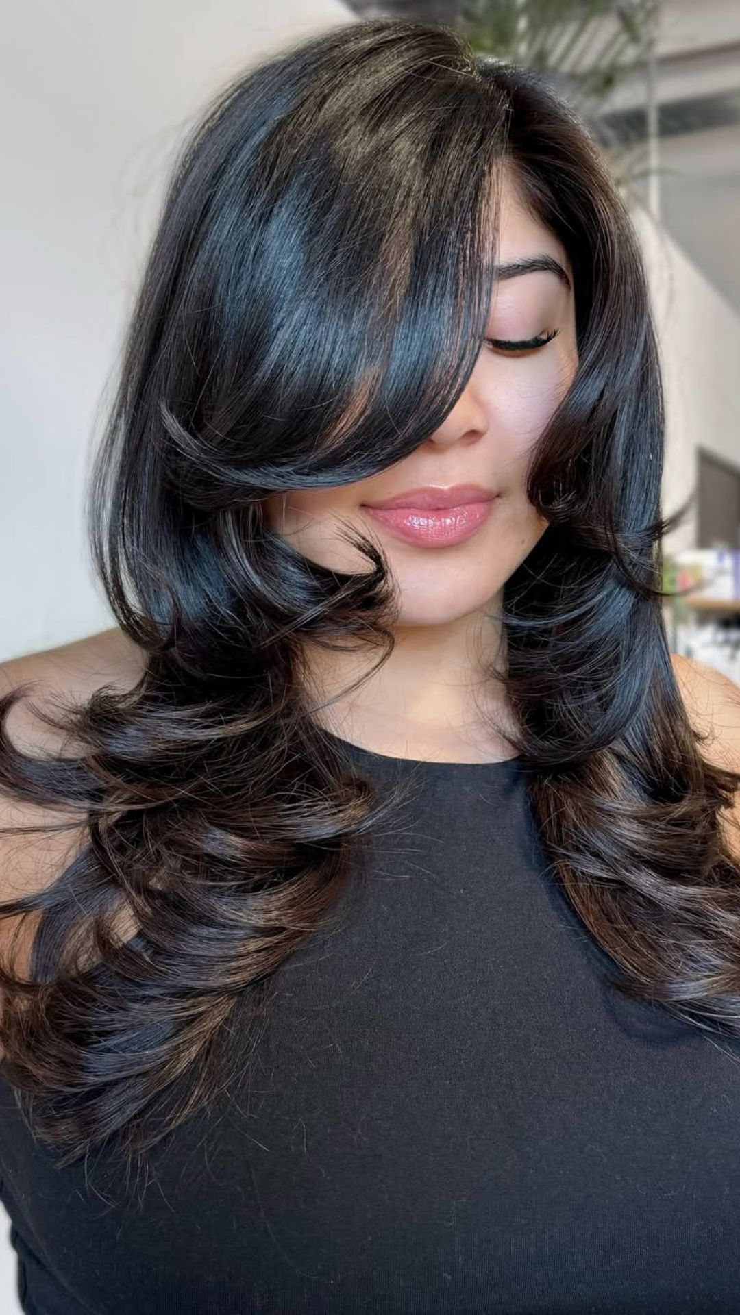 A round-faced woman with double chin modelling a Side Part hairstyle.