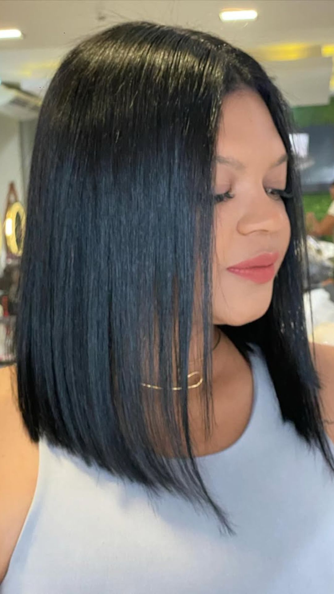 A round-faced woman with double chin modelling a Sleek Straight Hair hairstyle.