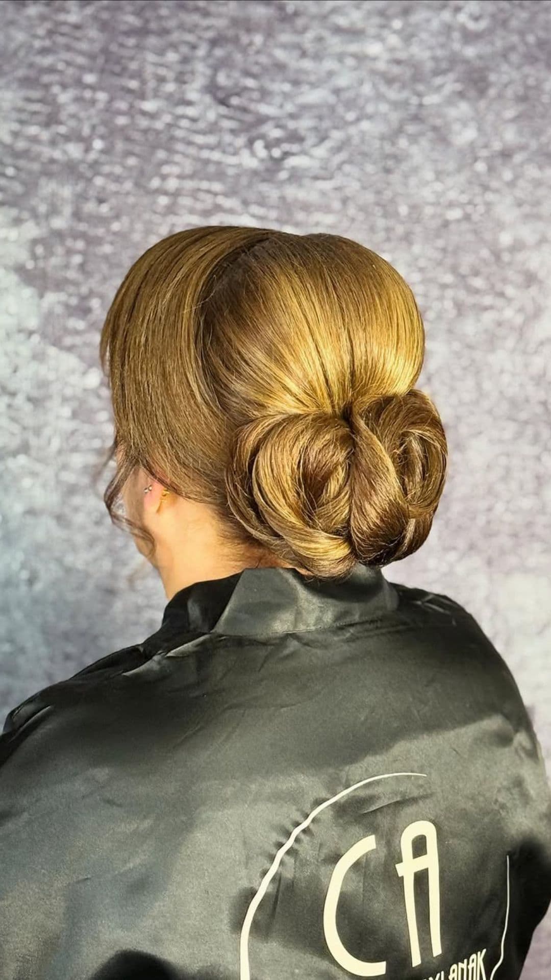 An old woman modelling a Sleek Updo hairstyle.