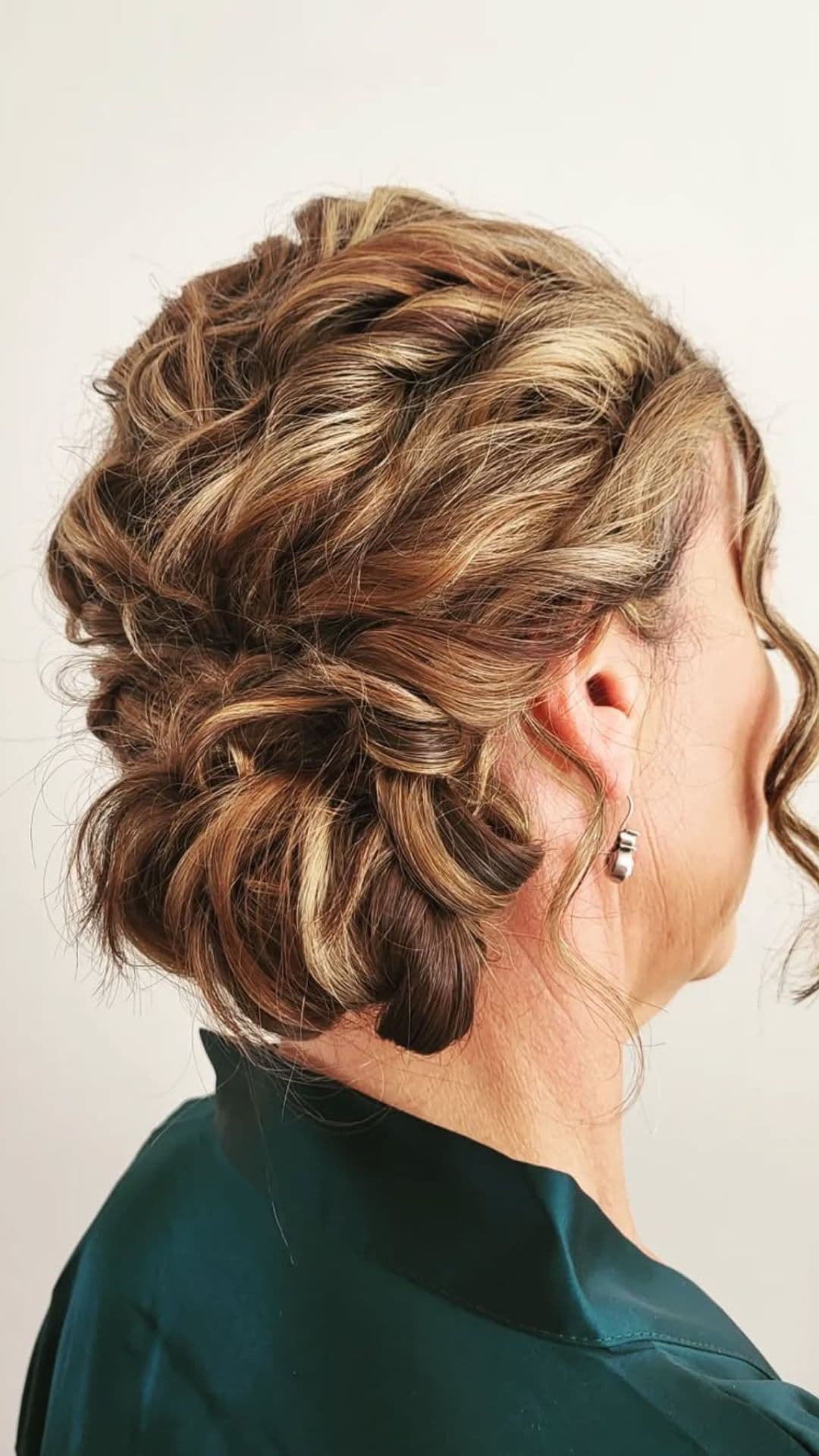 An old woman modelling a Soft Side Bun hairstyle.
