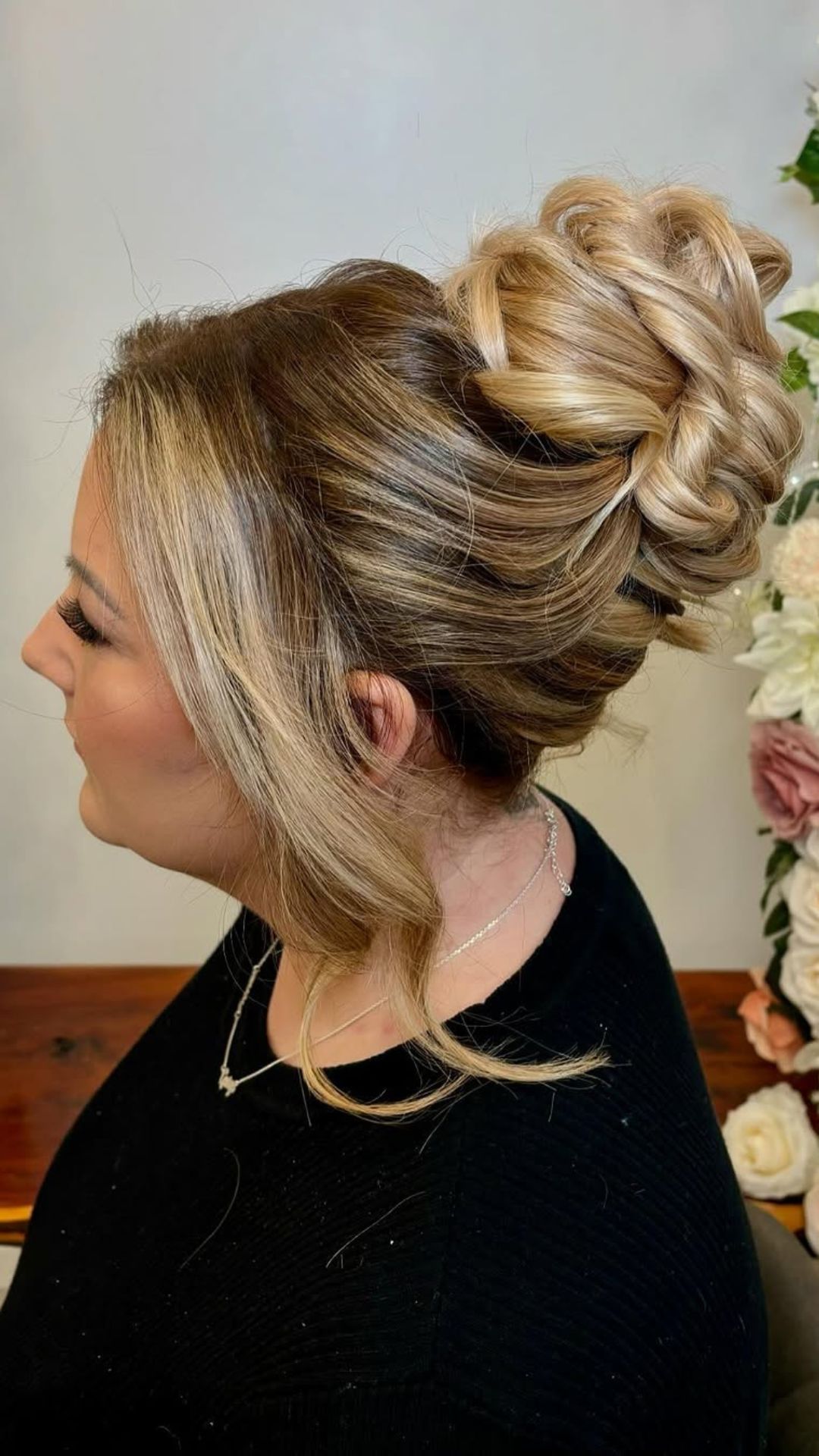 A round-faced woman with double chin modelling a Top Knot hairstyle.