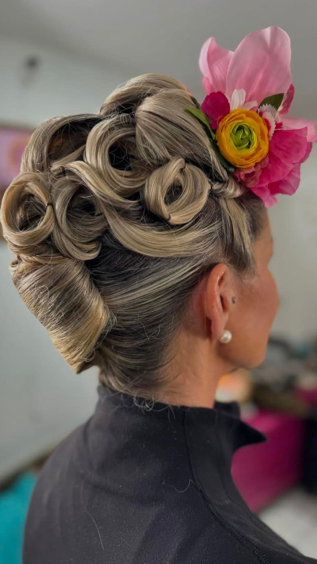 An old woman modelling a Vintage Roll Updo hairstyle.